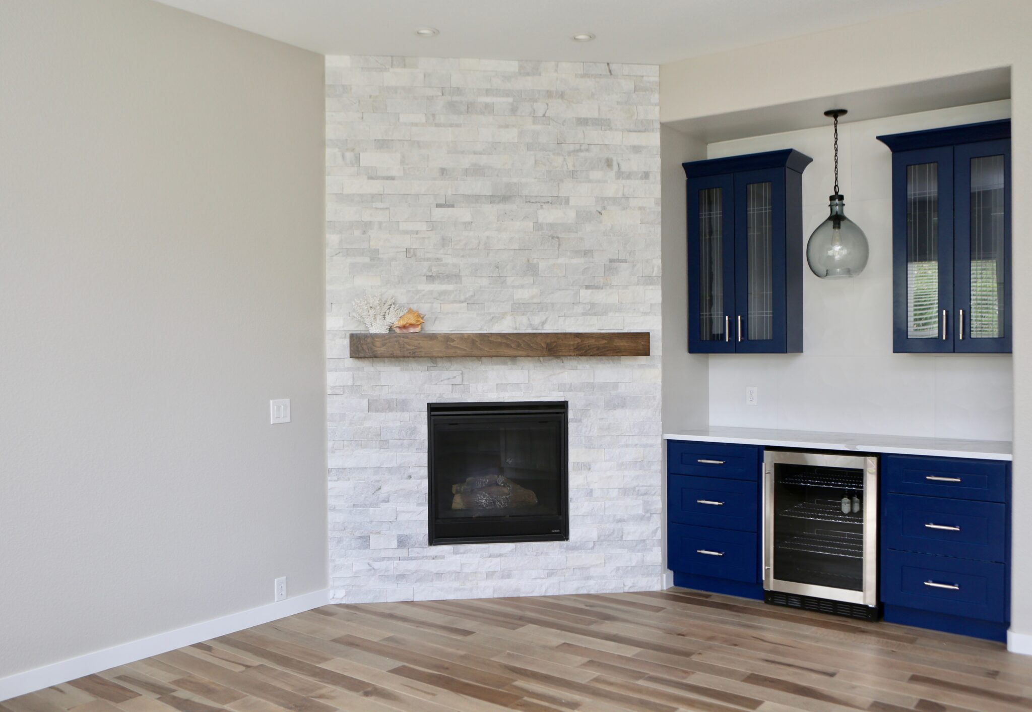  Living room with stone fireplace and navy blue built-in cabinets